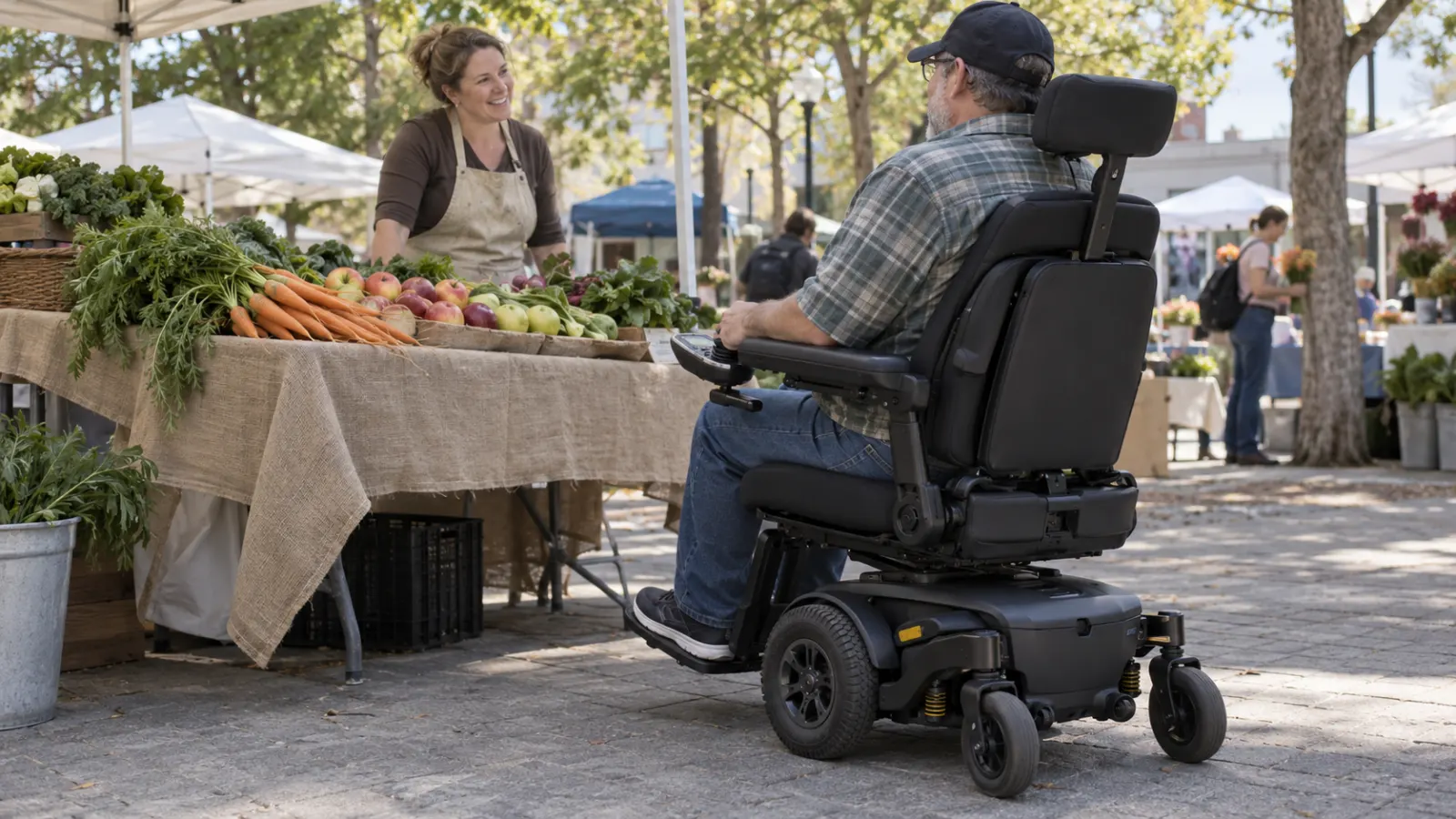 A power wheelchair user talks with a vendor at a produce stall.