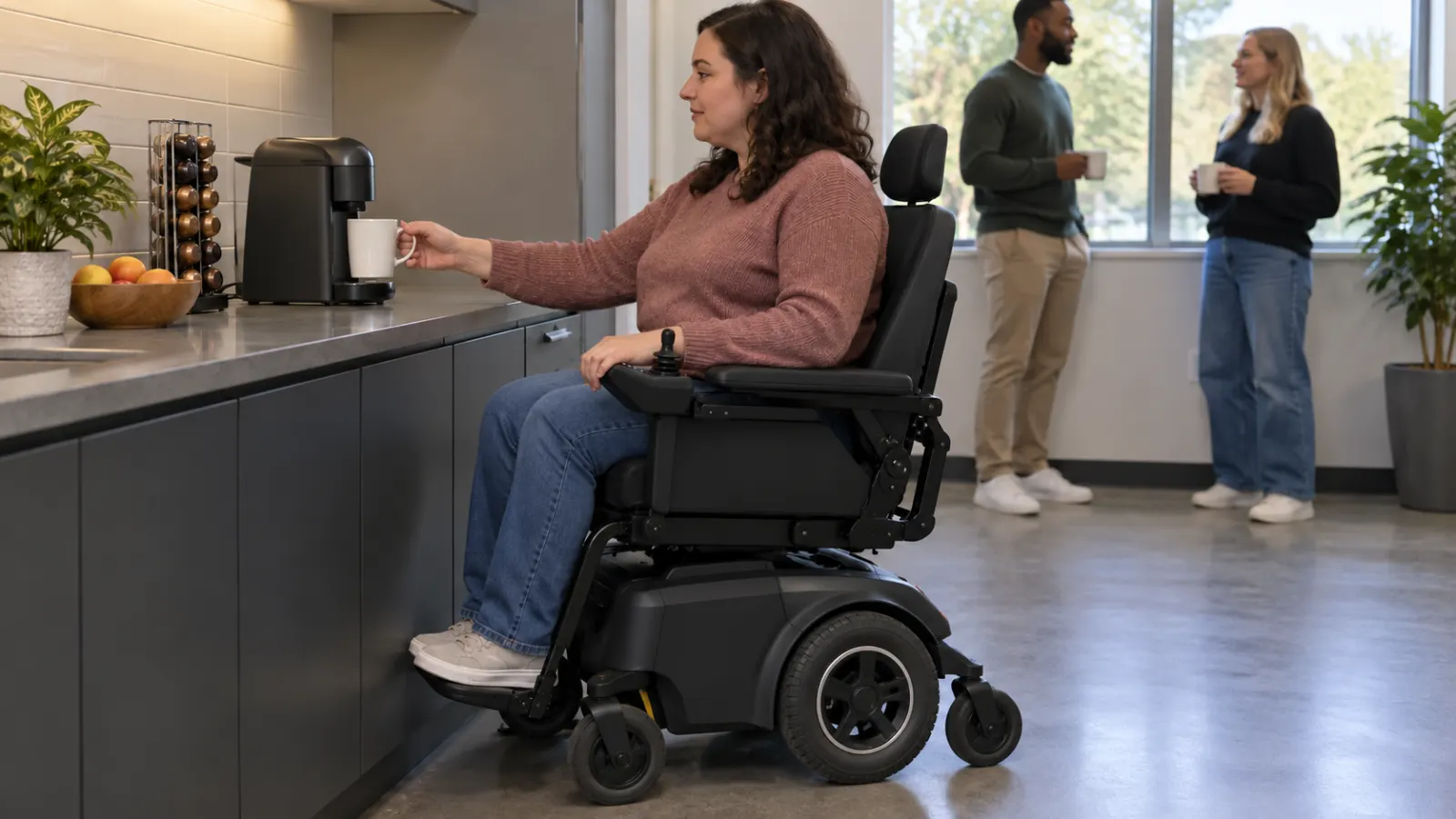 A power wheelchair user at a shared coffee counter.
